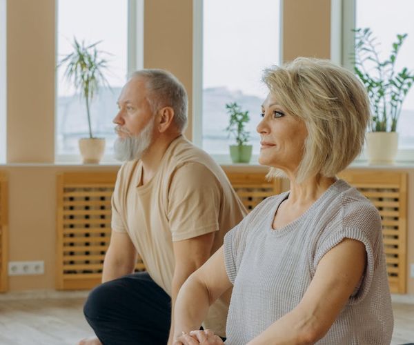 Diverse group of people of different ages enjoying a yoga class.