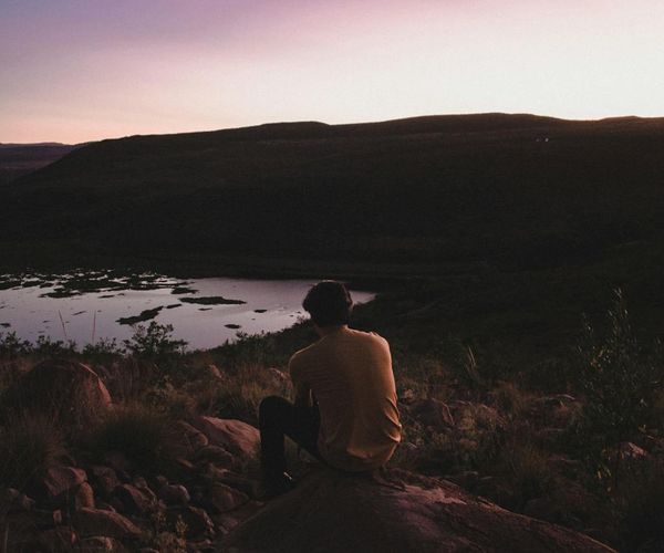 Silhouette of a person meditating at sunrise, symbolizing mental clarity.